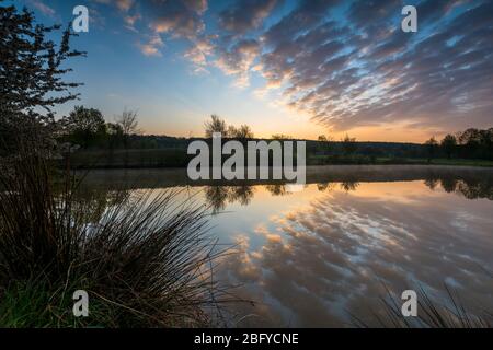 symmetrical cloud reflection in water at morning mood Stock Photo