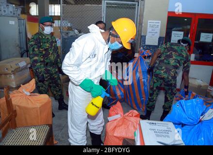 Colombo, Sri Lanka. 18th Apr, 2020. Staff members disinfect packages, which have arrived from overseas and stranded at the Postal Department, in Colombo, Sri Lanka, April 18, 2020. The Postal Department began functioning on Saturday after being closed for weeks following the COVID-19 outbreak. Credit: Ajith Perera/Xinhua/Alamy Live News