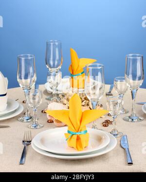 Table setting in white and yellow tones on color  background Stock Photo
