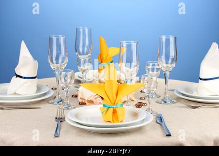 Table setting in white and yellow tones on color  background Stock Photo