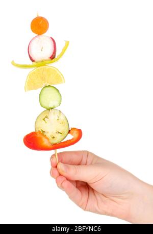 Sliced vegetables on wooden pick holding in hand isolated on white Stock Photo