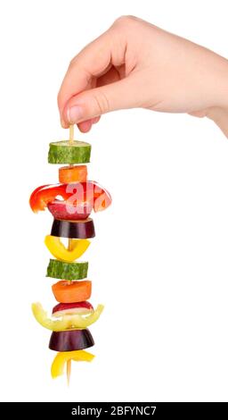 Sliced vegetables on wooden pick holding in hand isolated on white Stock Photo