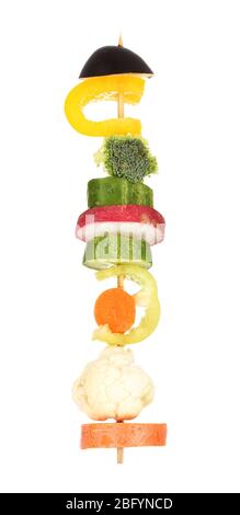 Sliced vegetables on wooden pick holding in hand isolated on white Stock Photo