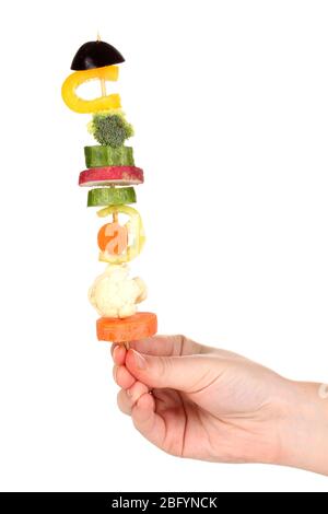 Sliced vegetables on wooden pick holding in hand isolated on white Stock Photo
