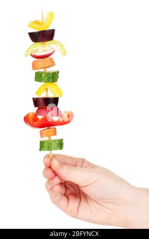 Sliced vegetables on wooden pick holding in hand isolated on white Stock Photo