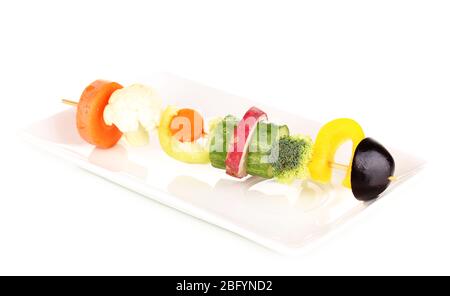 Sliced vegetables on wooden pick isolated on white Stock Photo