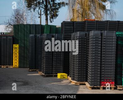 Black plastic boxes in a warehouse outdoor. Stock Photo