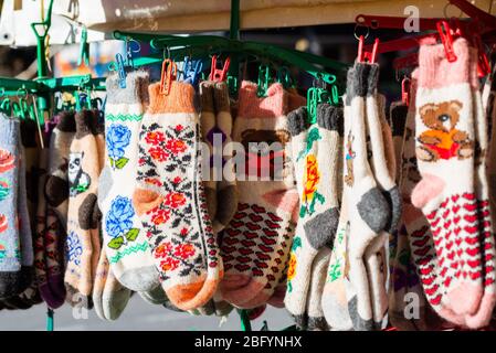 Traditional knitted socks as rural souvenirs on street market. Stock Photo
