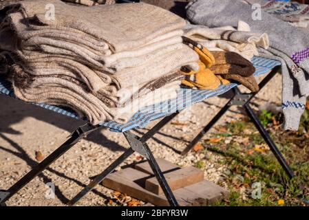 Traditional knitted scarves as rural souvenirs on street market. Stock Photo