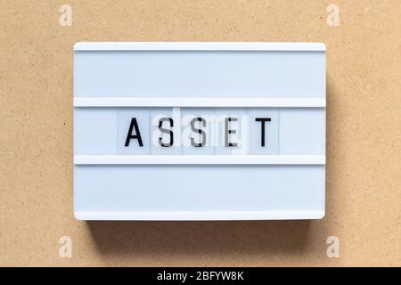 White lightbox with word asset on wood background Stock Photo