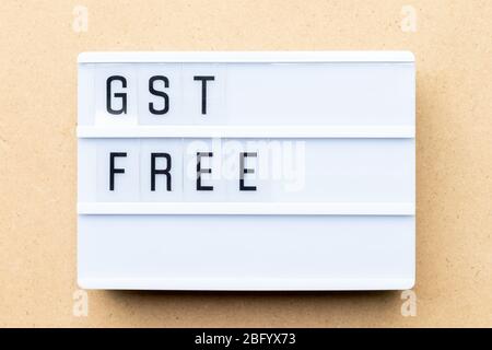 White lightbox with word GST (Abbreviation of Goods and Service Tax) free on wood background Stock Photo