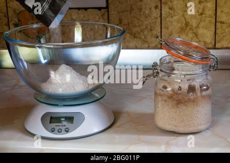 Bread flour in weighing scales Stock Photo - Alamy