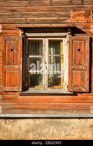 windows with open shutters of an ancient wooden house Stock Photo