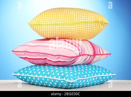 Blue, pink and yellow bright pillows isolated on white Stock Photo Alamy