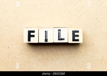 Alphabet letter block in word file on wood background Stock Photo