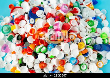 Top view of huge number of plastic bottle caps of different sizes, shapes and colors. Plastic recycling concept. Stock Photo