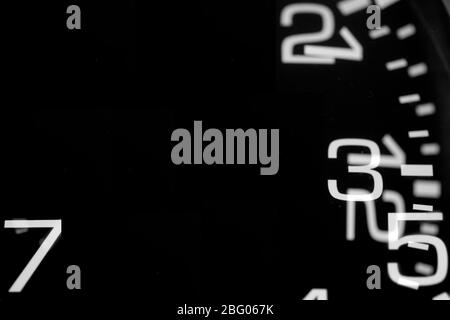 double exposure of a black clock showing numbers Stock Photo