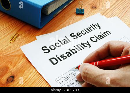 Man filling in Social Security Disability Claim. Stock Photo