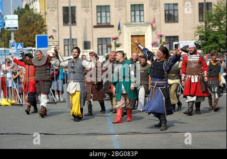 Reenactors dressed in armor of an Old Russian footmen dancing after fight reconstruction Stock Photo