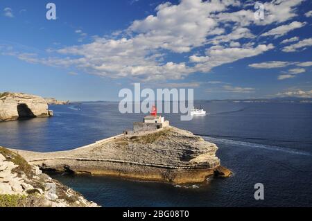 The lighthouse Phare de la Madonette at the harbor entrance of Bonifacio, in the background Sardinia, Corsica, France, Europe Stock Photo