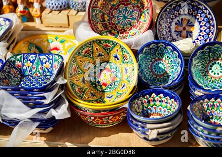 Blue and yellow decorative ceramic plates on street market in the city of Bukhara, Uzbekistan Stock Photo