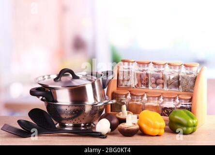 composition of kitchen tools,spices and vegetables on table in kitchen Stock Photo