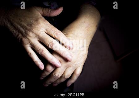 Hands of elderly woman doing a selfmassage. Manual physiotherapy Stock Photo