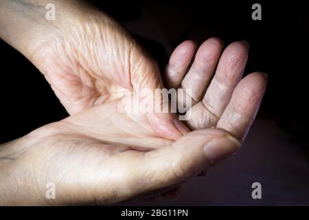 Hands of elderly woman doing a selfmassage. Manual physiotherapy Stock Photo