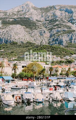 makarska riviera croatia background. Dalmatia region. Mountains and old town with sea view harbour with boats. Stock Photo