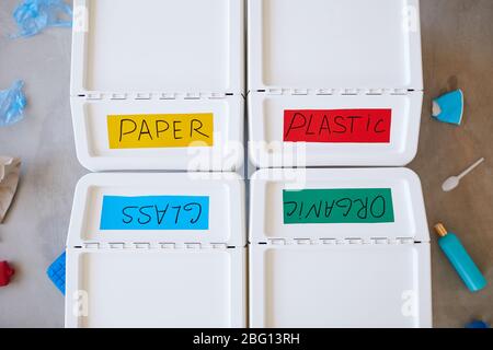 Above view background of four plastic bins labeled for storage and sorting waste at home, copy space Stock Photo