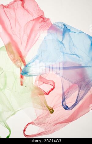 Top view background of colored plastic bags on backlit white background, copy space Stock Photo