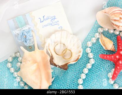 Border of romantic pink and white hearts in fishing net with an edge  decoration of corks in vertical format on rustic turquoise blue boards with  copyspace for your Valentine or anniversary greeting