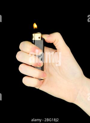 Burning lighter in female hand, isolated on black Stock Photo