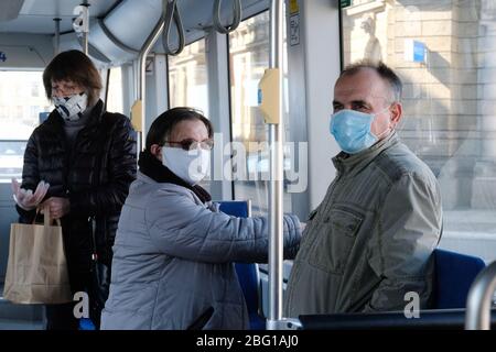 Leipzig, Germany. 20th Apr, 2020. Passengers stand in a tram and wear mouthguards. As of today (20.04.2020), mouthguards are compulsory in public transport and shops in Saxony. Credit: Sebastian Willnow/dpa-Zentralbild/dpa/Alamy Live News Stock Photo