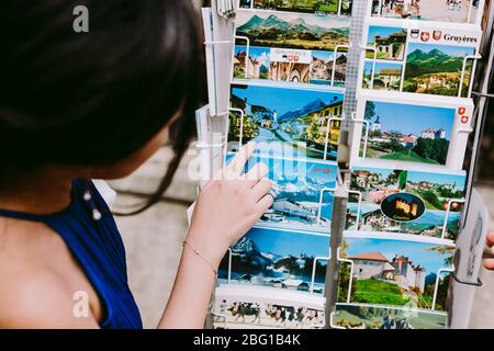 swiss souvenirs bells and magnets with post cards from switzerland. Swiss bells. Stock Photo