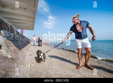 Dog walkers on Paignton seafront during the Coronavirus lockdown, UK Stock Photo