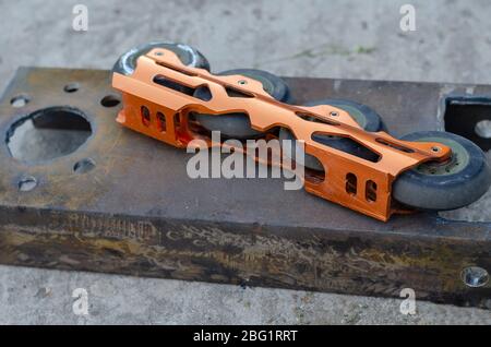 Aggressive inline skates disassembled. Professional roller blades on the floor. Hard alloy roller blade. Repair of sports equipment. Overhead view Stock Photo