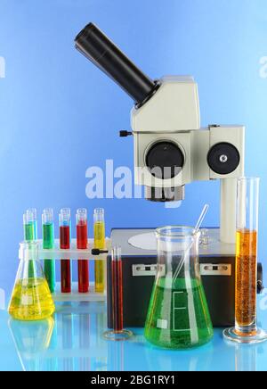 Test tubes with colorful liquids and microscope in blue light Stock ...
