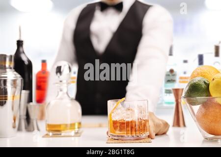 Barman serving whiskey drink in a bar Stock Photo