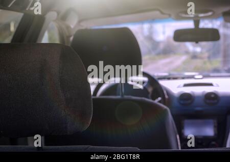 Car interior without people. Empty seats of a modern car. Shooting from the rear seat in the direction of the windshield. Travel by car. Selective foc Stock Photo