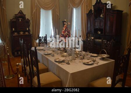 An elegant dining room set for a formal meal in a historic mansion. Stock Photo