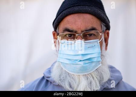 Volunteers at Central Jamia Mosque Ghamkol Sharif in Birmingham, which is operating a temporary morgue during the Covid-19 pandemic. The mosque already runs one of the city's oldest Muslim funeral services, and is accepting deceased of all faiths in separate coronavirus and non-coronavirus facilities. Stock Photo