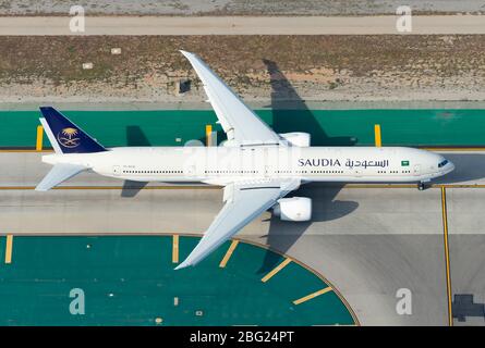 Saudia Airlines Boeing 777 taxiing at Los Angeles International Airport. Boeing 777-300 airplane HZ-AK40 aerial view. Saudi Arabian Airlines. Stock Photo