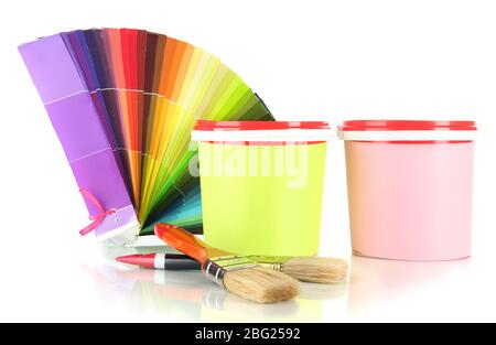 Paint pots, paintbrushes and coloured swatches isolated on white Stock Photo