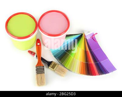 Paint pots, paintbrushes and coloured swatches isolated on white Stock Photo