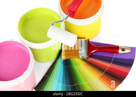 Paint pots, paintbrushes and coloured swatches close up Stock Photo