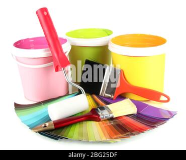 Paint pots, paintbrushes and coloured swatches close up Stock Photo