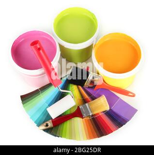 Paint pots, paintbrushes and coloured swatches isolated on white Stock Photo