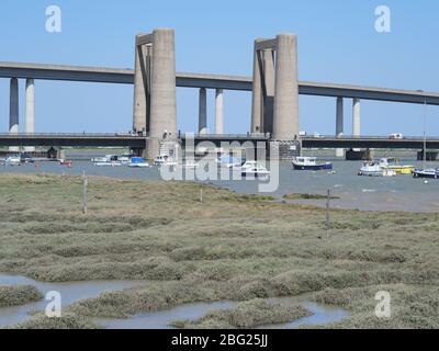 Iwade, Kent, UK. 20th Apr, 2020. Today is the 60th anniversary of the distinctive Kingsferry Bridge, linking Isle of Sheppey with mainland Kent, being opened by the Duchess of Kent on 20 Apr, 1960. At the time it was the largest lifting bridge built in Britain since the Second World War. There is only one other similar design in the world based in Holland. In 2006, the infamous Sheppey Crossing was opened, but Kingsferry was retained for rail and road traffic. A generator is in situ for lifting the centre span as the power system needs a replacement part. Credit: James Bell/Alamy Live News Stock Photo