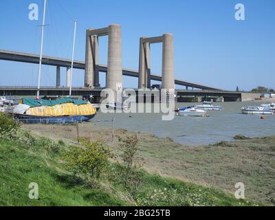 Iwade, Kent, UK. 20th Apr, 2020. Today is the 60th anniversary of the distinctive Kingsferry Bridge, linking Isle of Sheppey with mainland Kent, being opened by the Duchess of Kent on 20 Apr, 1960. At the time it was the largest lifting bridge built in Britain since the Second World War. There is only one other similar design in the world based in Holland. In 2006, the infamous Sheppey Crossing was opened, but Kingsferry was retained for rail and road traffic. A generator is in situ for lifting the centre span as the power system needs a replacement part. Credit: James Bell/Alamy Live News Stock Photo